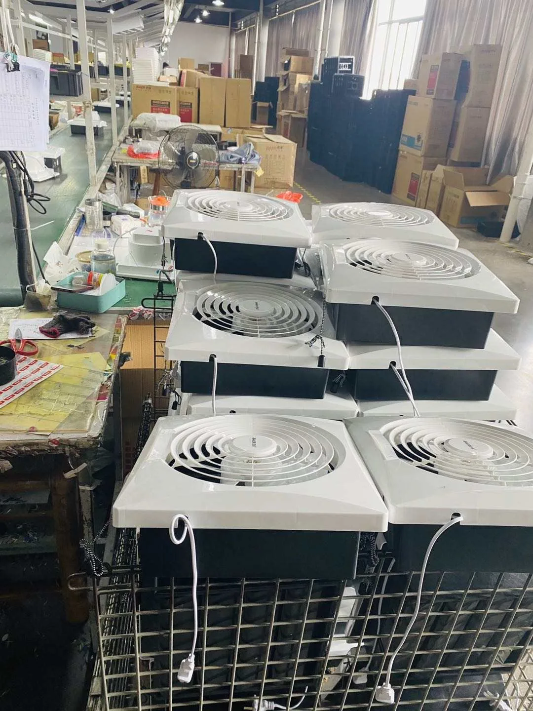 Finished ceiling panel exhaust fans staged on the assembly floor at the BAER factory